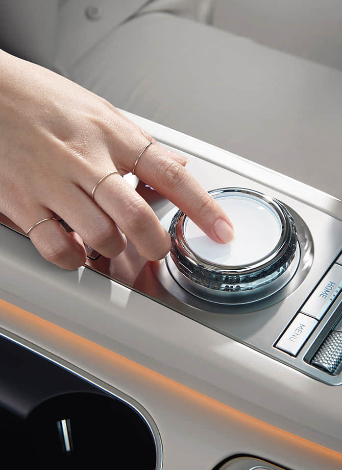 The Genesis steering wheel appears enlarged.