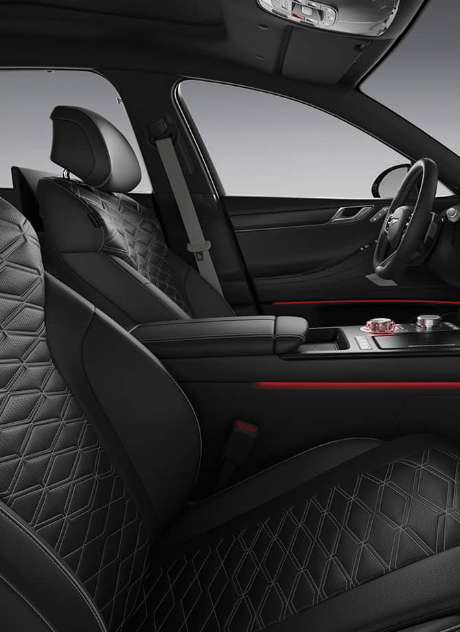 The Genesis steering wheel appears enlarged.