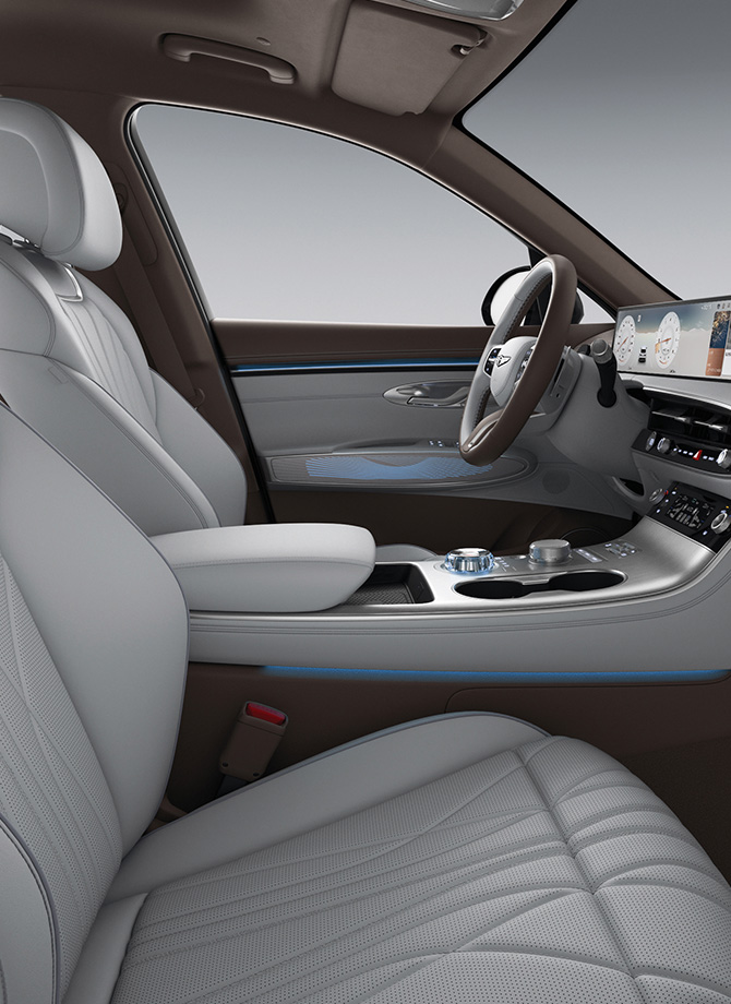 The Genesis steering wheel appears enlarged.