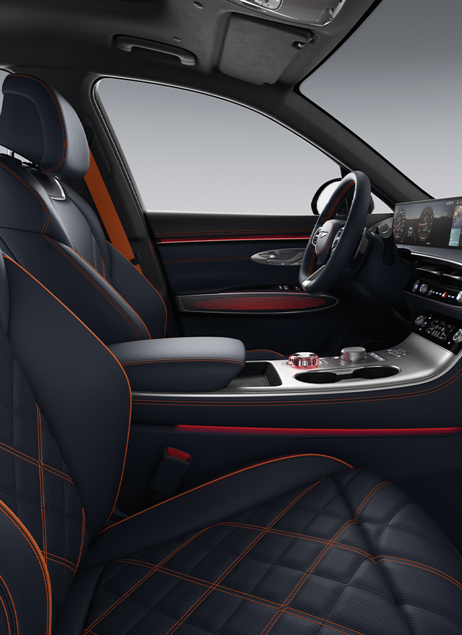 The Genesis steering wheel appears enlarged.