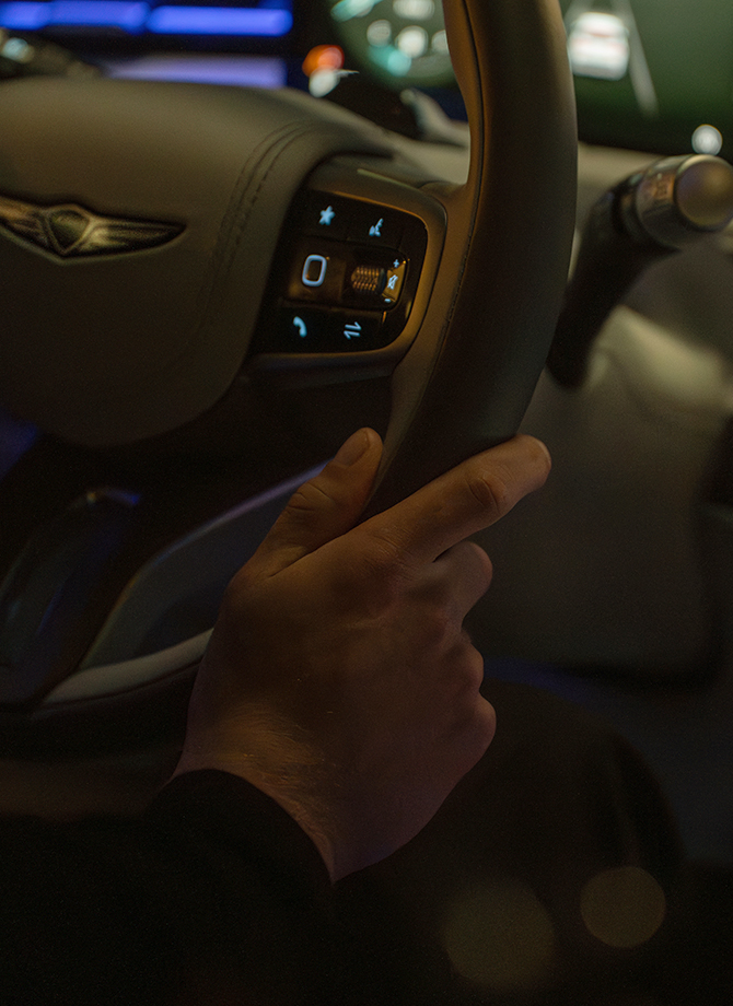 The Genesis steering wheel appears enlarged.