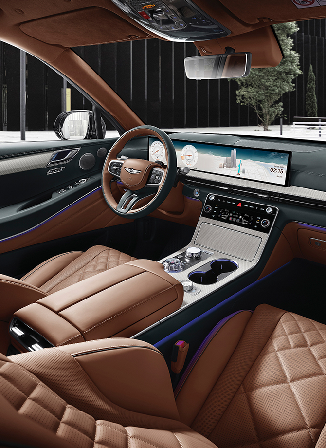 The Genesis steering wheel appears enlarged.