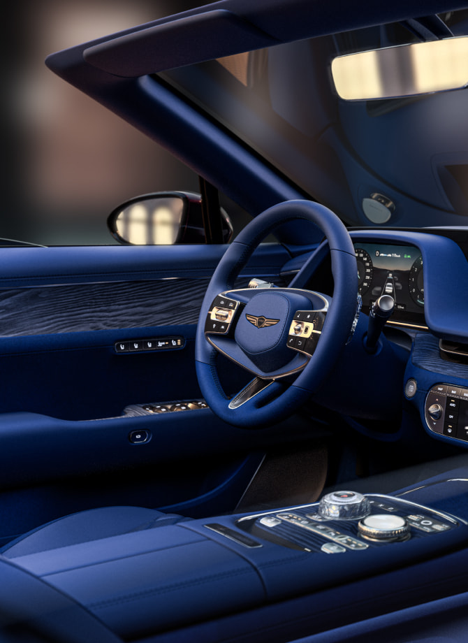 The Genesis steering wheel appears enlarged.